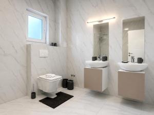 a white bathroom with a sink and a toilet at Vila Gaia in Sarajevo +11 photos