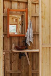 a wooden bathroom with a sink and a mirror at Soul Farm Algarve - Glamping & Farm Houses in Aljezur +73 photos