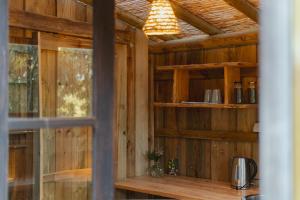 a room with a wooden wall with a window at Soul Farm Algarve - Glamping & Farm Houses in Aljezur