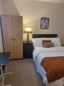 a bedroom with two beds and a table and a lamp at Bellmullet, Waterside Townhouse in Belmullet