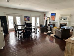 a living room with a table and chairs and a couch at Deluxe Farm Studio Apt with Pool View in Alachua +4 photos