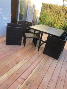 a patio with a table and chairs on a deck at Chambre sympa in La Chapelle-sur-Erdre