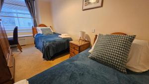 a bedroom with two beds and a window at The Ship Inn Looe in Looe