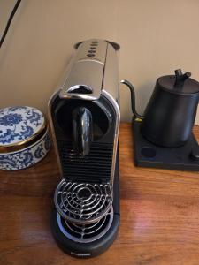 a coffee maker sitting on top of a table at Villa Oasis in Lelystad