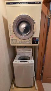 a washing machine and a dryer in a room at Shimano Yado Rishirikuru in Rishiri +9 photos