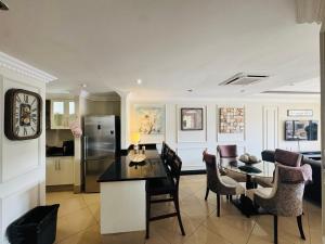 a kitchen and dining room with a table and chairs at The Sails-Luxe Penthouse By Ezey Tours in Durban