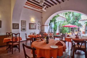 a restaurant with tables and chairs and an archway at Dune de L'orient in Pondicherry +27 photos