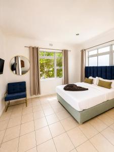 a bedroom with a large bed and a mirror at 12 On Braemar Guesthouse in Cape Town