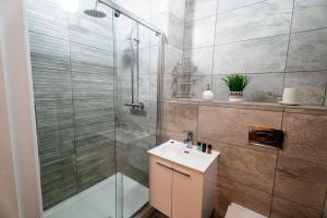a bathroom with a shower and a sink at Chapel Retreat | King Bed | Central Swansea in Swansea +39 photos