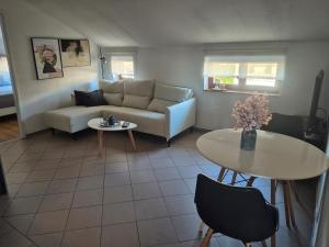 a living room with a couch and a table at Apartment Vdovjak in Malinska