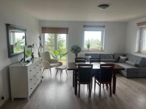 a living room with a table and a couch at Agroturystyka Nad Jeziorem Piecki in Piecki