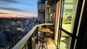 a balcony with a table and a view of a city at LK Funcionários 6 in Belo Horizonte +31 photos