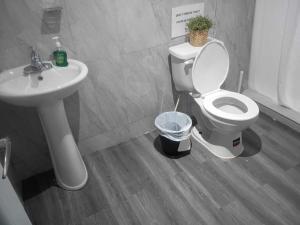 a bathroom with a toilet and a sink at Downtown Studio at San Juan JL Guaynabo in San Juan