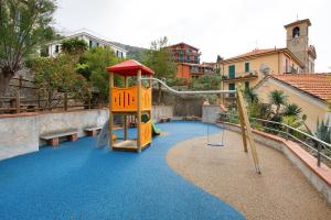 a playground with a slide and a swing set at Terrazza nel Vigneto - Free parking in Tellaro