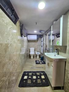 a bathroom with a sink and a toilet at Вила ОРЕХИТЕ in Dupnitsa +24 photos