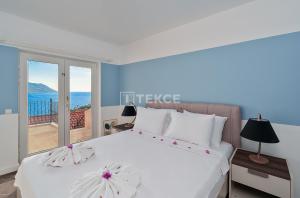 a bedroom with a bed with a view of the ocean at TEKCE Villa Mae N3 in Yeniköy +35 photos