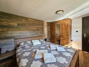 a bedroom with a bed with towels on it at Вила ОРЕХИТЕ in Dupnitsa