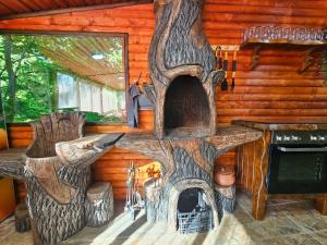 a log cabin with a fireplace in the living room at Вила ОРЕХИТЕ in Dupnitsa