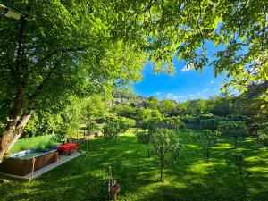 a view of a park with trees and a pool at Вила ОРЕХИТЕ in Dupnitsa
