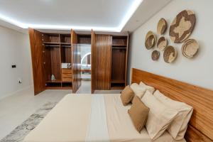 a bedroom with a large bed and some hats on the wall at Sharksproperties Luxury 3BR Ocean View Apartment with Rooftop Pool 6 Guests in Mindelo +44 photos