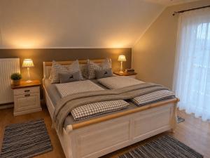 a bedroom with a large bed with two night stands at EulenHorst - Ferienhaus in Seeboden am Millstätter See mit Sonnenterasse & Bergblick in Seeboden