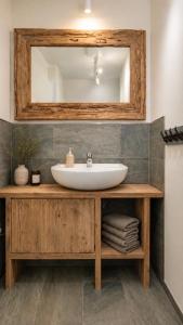 a bathroom with a sink and a mirror at EulenHorst - Ferienhaus in Seeboden am Millstätter See mit Sonnenterasse & Bergblick in Seeboden +29 photos