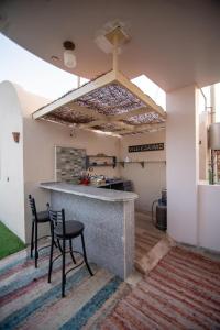 a kitchen with two chairs and a counter in a room at Sunny sea in Quseir