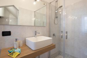 a bathroom with a sink and a shower at Bebyme - EPICENTRUM in La Spezia +17 photos
