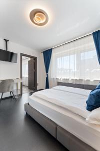 a bedroom with a large bed and a window at Air Linz Residence in Linz