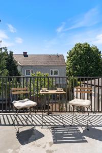 a patio with two tables and chairs on a fence at Air Linz Residence in Linz