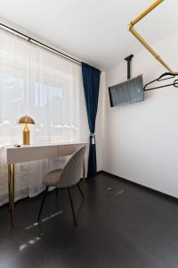 a room with a desk and a chair and a window at Air Linz Residence in Linz
