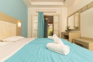 a large blue bed with towels on top of it at Porto Koukla Beach in Lithakia
