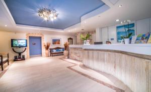 a large lobby with a bar and a tv at Porto Koukla Beach in Lithakia