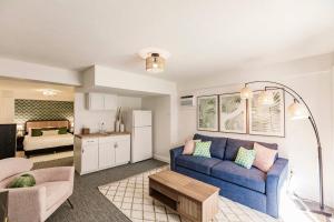 a living room with a blue couch and a kitchen at Casa Marco - Heated Pool, Game Room, Mini Golf in Marco Island