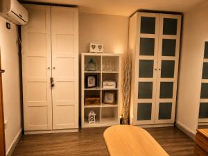 a living room with white cabinets and a book shelf at Casina Appia Antica in Marino