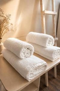 three towels sitting on a table with a ladder at Casina Appia Antica in Marino