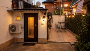 a door leading to a patio with a table and chairs at Casina Appia Antica in Marino