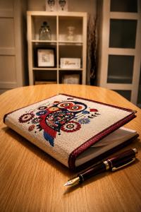 a notebook sitting on top of a table with a pen at Casina Appia Antica in Marino +24 photos
