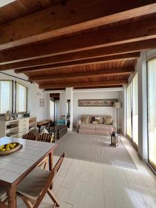 a living room with a table and a couch at I tre platani in Marina di Massa