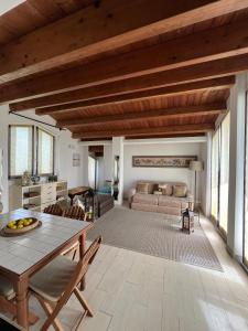 a living room with a table and a couch at I tre platani in Marina di Massa