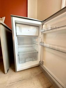 an empty refrigerator with its door open in a kitchen at Alpha - City Center Rooms Athens in Athens