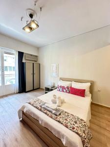 a bedroom with a large bed with red pillows at Alpha - City Center Rooms Athens in Athens