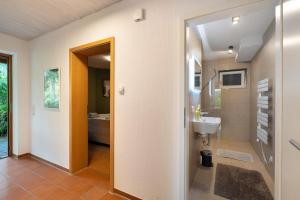 a bathroom with a toilet and a sink at Haus Ersfeld – Gartenwohnung in Bad Teinach-Zavelstein +23 photos