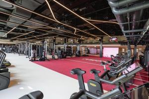 a gym with lots of cardio equipment on a red carpet at NOTO Hotel in Luxembourg