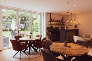 a living room with two tables and chairs at Huyze Fox - Boutique Stays in Bruges
