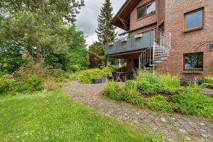 a house with a balcony on the side of it at Haus Ersfeld – Gartenwohnung in Bad Teinach-Zavelstein