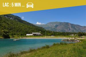 a picture of a lake with mountains in the background at Le Domi Hyper Centre Proche Cols Stations in Saint-Jean-de-Maurienne