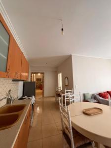a kitchen with a table and a counter top at Milto's Rooms in Himare