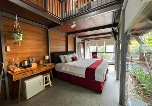 a bedroom with a bed and a desk in a room at villa tibra in Lembang