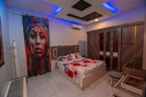 a bedroom with a large painting of a woman at New Villa Carimo in Quseir